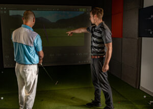 Next Level Golf Academy lesson showing coach explaining Trackman data
